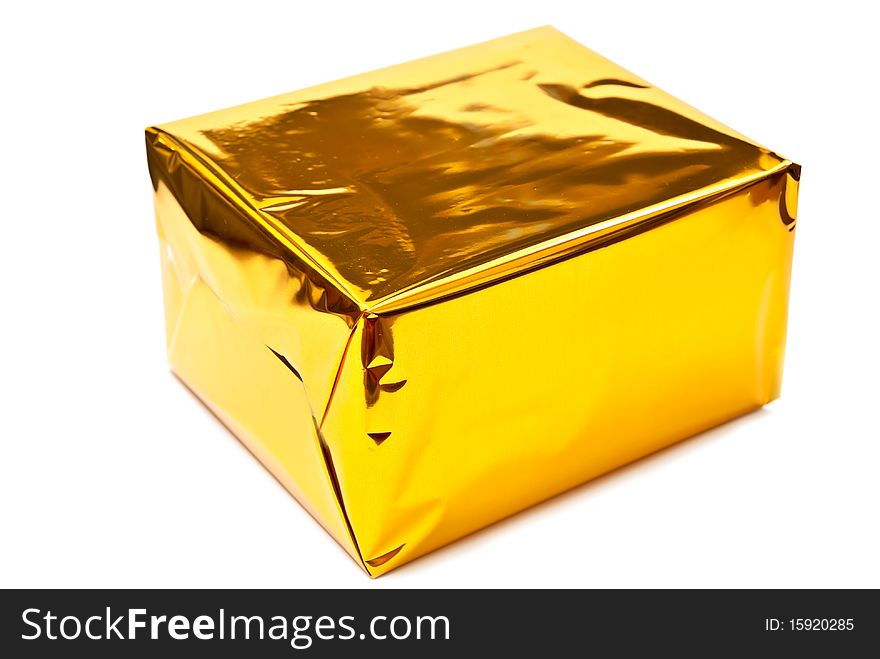 Single golden gift box. Isolated on white