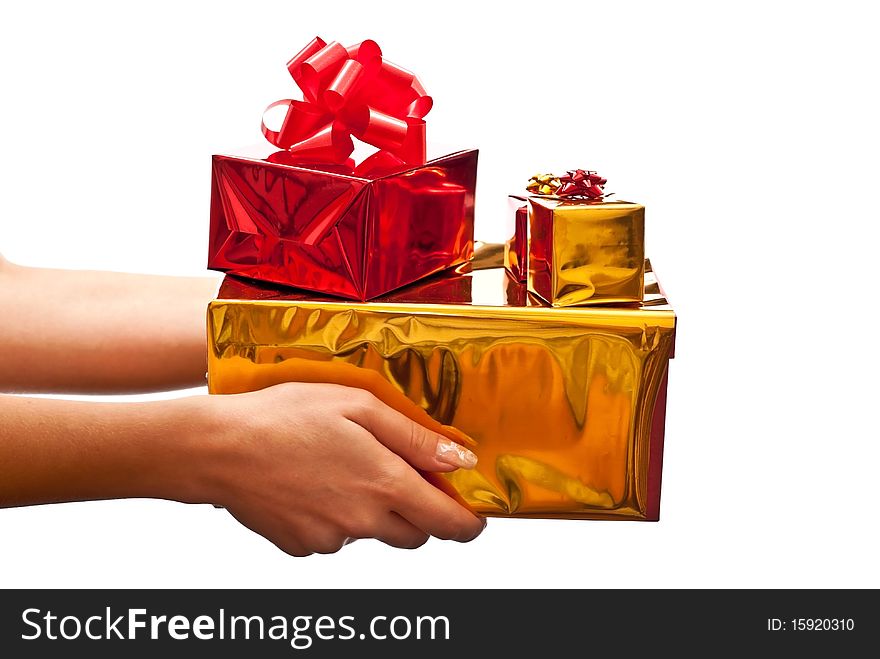 Woman's hand with a red and yellow gifts boxes. Isolated on white