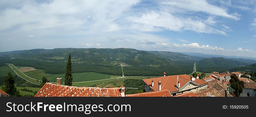 Panoramic landscape consisting of mountains, forests and sky