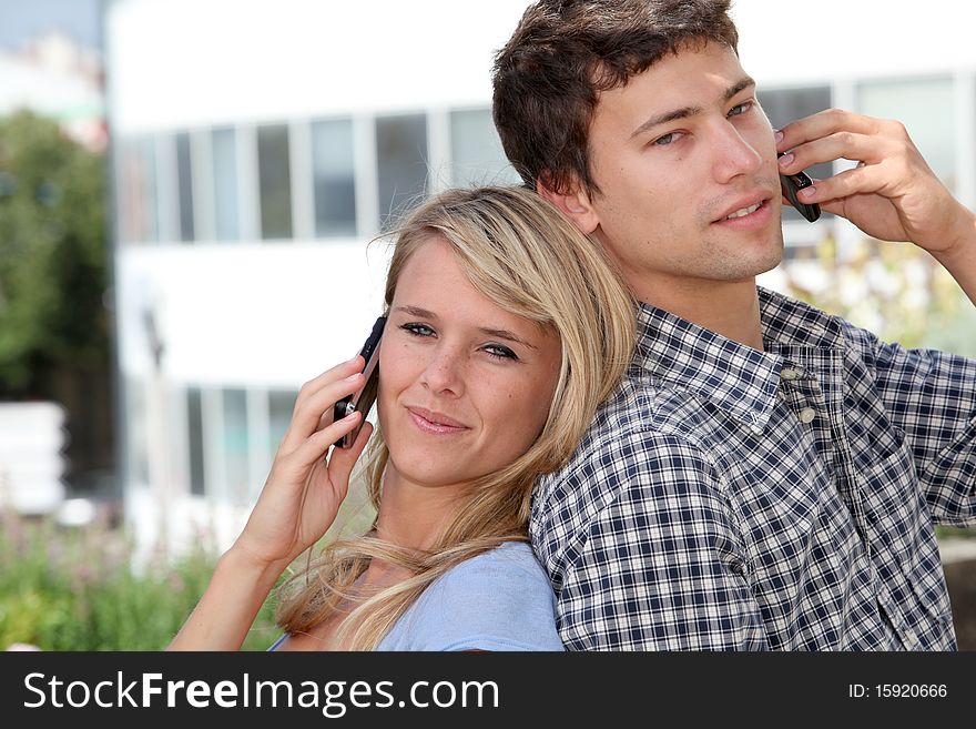 Young couple of students with mobile phone. Young couple of students with mobile phone