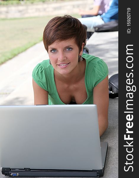 Student with laptop computer in college park. Student with laptop computer in college park