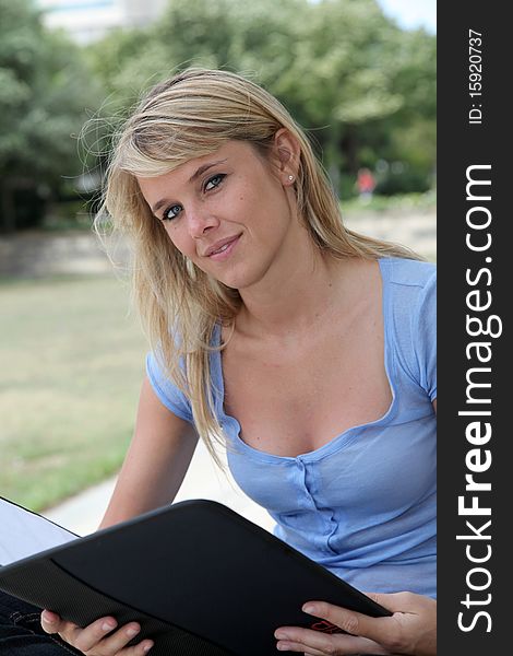 Closeup of beautiful blond woman sitting in park. Closeup of beautiful blond woman sitting in park