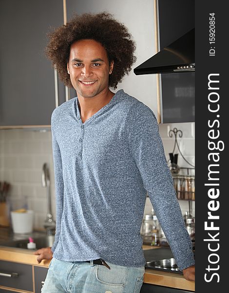 Young man standing in kitchen. Young man standing in kitchen