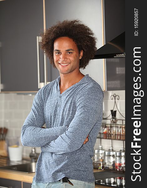 Young man standing in kitchen. Young man standing in kitchen