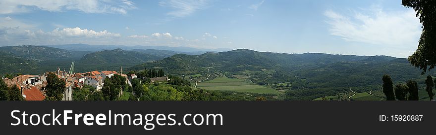 Panoramic landscape consisting of mountains, forests and sky
