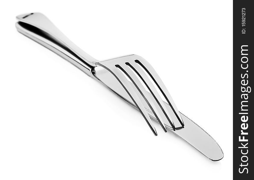 Close up abstract of a silver knife and fork on a white background with space for text