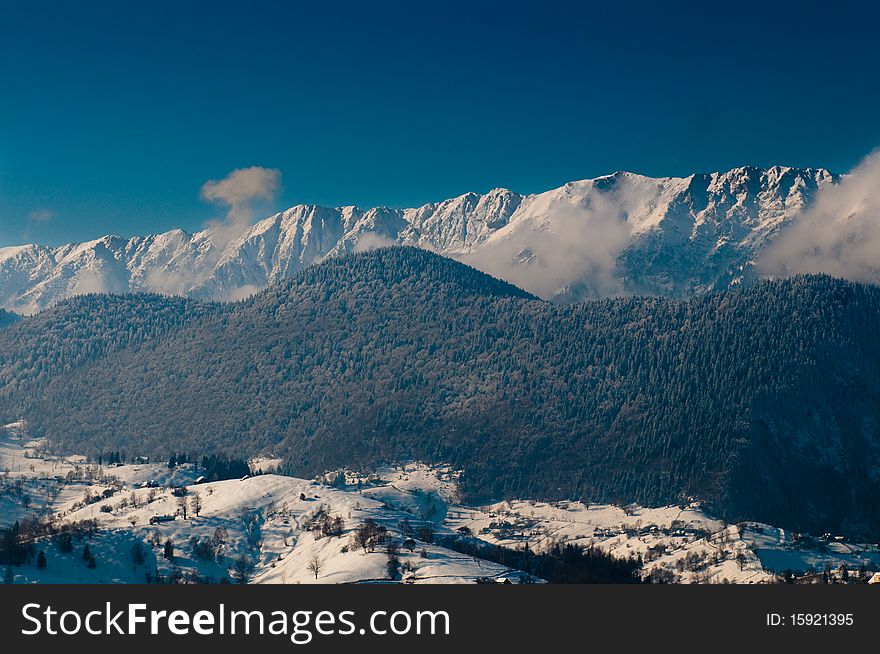 Winter Landscape: Clouds and Mountains over village