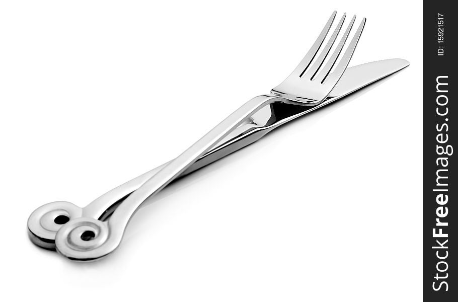 Close up abstract of a silver knife and fork on a white background with space for text