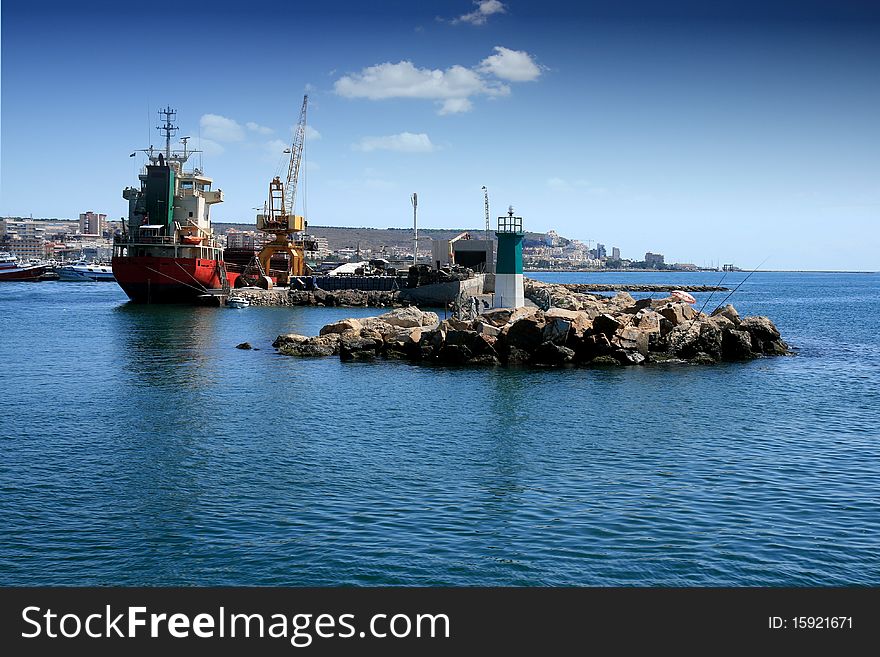 Boat and lighthouse in the port of Santa Pola