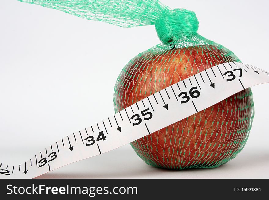 Closeup of an apple in a net with 36 measurement