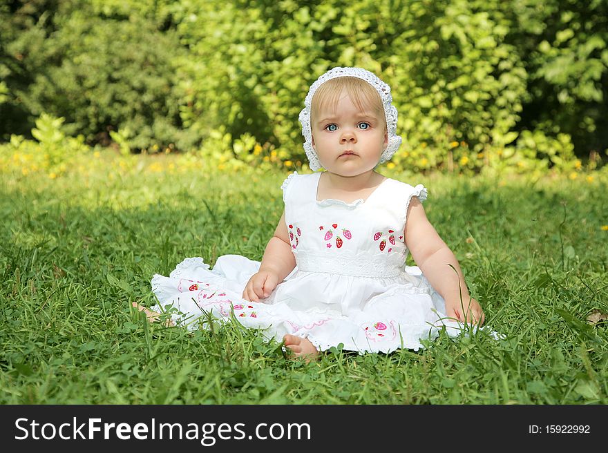 Portrait of cute little girl with blue eyes in white dress outdoor shot. Portrait of cute little girl with blue eyes in white dress outdoor shot