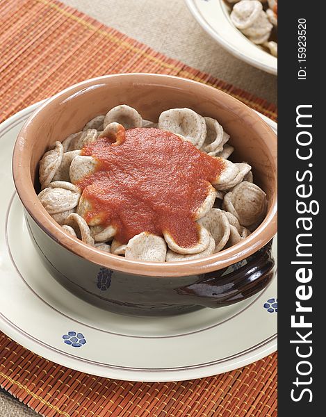 South italian traditional recipe "orecchiette" pasta with tomato sauce