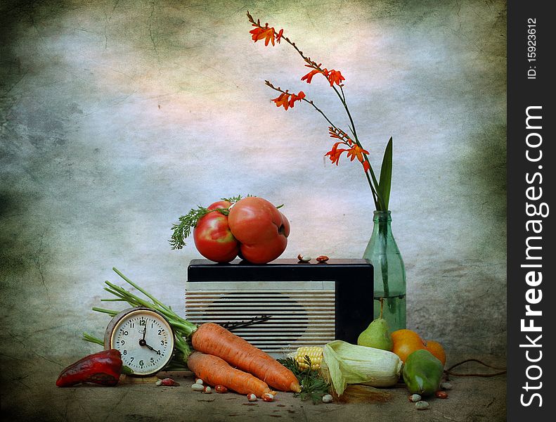 Still life consists of old radio, vegetables, alarm clock and flower. Still life consists of old radio, vegetables, alarm clock and flower