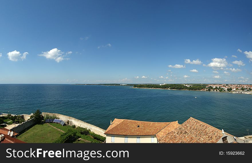 Panoramic landscape with the sky, the sea and rooftops, Porec, Croatia