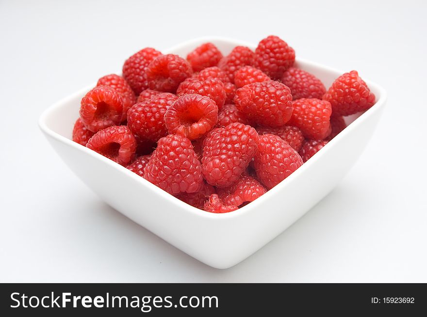 A full bowl of fresh healthy raspberries. A full bowl of fresh healthy raspberries