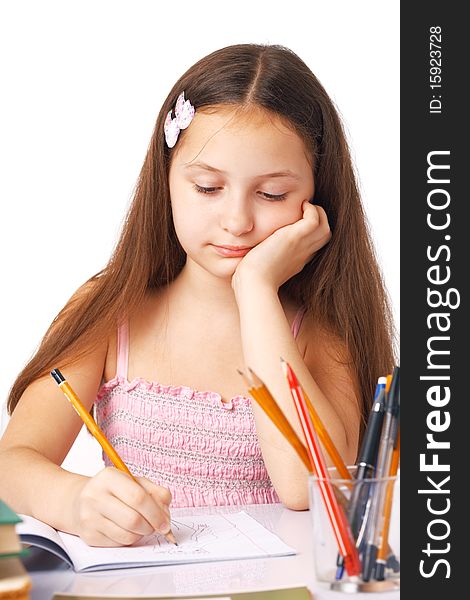 Cute little girl sketching something in the copybook. Cute little girl sketching something in the copybook