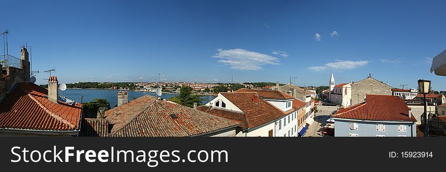 Panoramic landscape with the sky, the sea and rooftops, Porec, Croatia