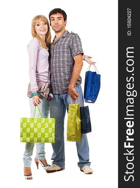 Beautiful young couple with shopping bags, isolated on white background