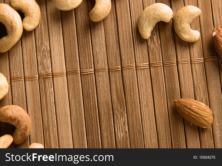 Nuts On Bamboo Background