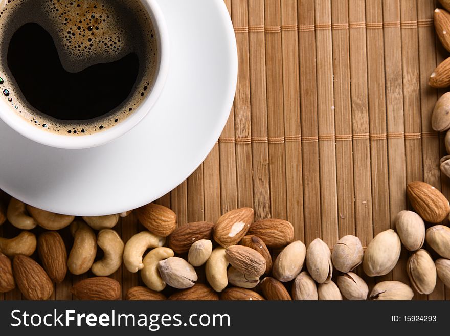 Cup of coffee with nuts. Focus on coffee foam