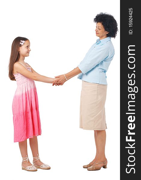 A full length portrait of grandmother holding hands with  her granddaughter. A full length portrait of grandmother holding hands with  her granddaughter.