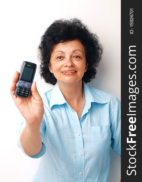 Elder smiling woman holding and showing her mobile. Elder smiling woman holding and showing her mobile.