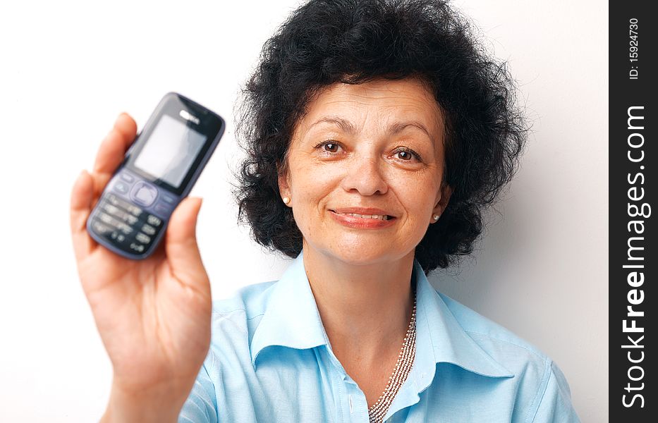 Close-up of an elder smiling woman holding and showing her mobile. Close-up of an elder smiling woman holding and showing her mobile.