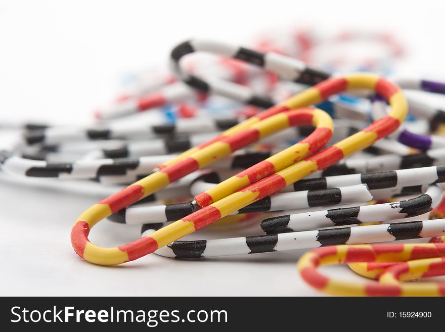 Colored paper clips office on a white background