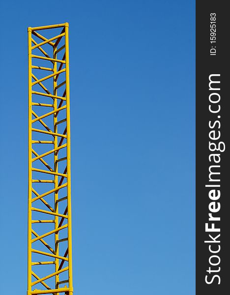 Abstract yellow metal construction over blue sky. Abstract yellow metal construction over blue sky