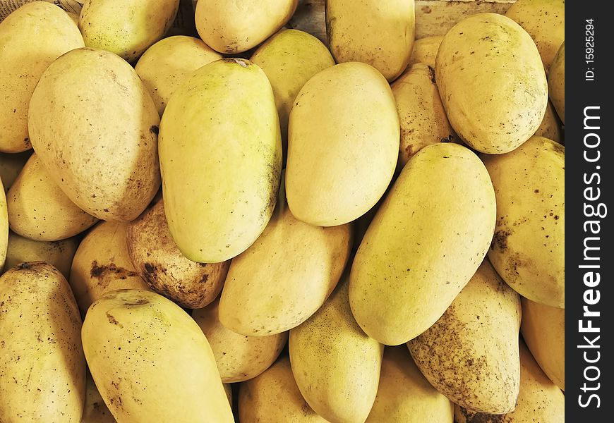 Stack of ripe, yellow mangoes in Asian market. Stack of ripe, yellow mangoes in Asian market