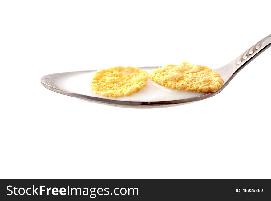 Cornflakes with milk on white background