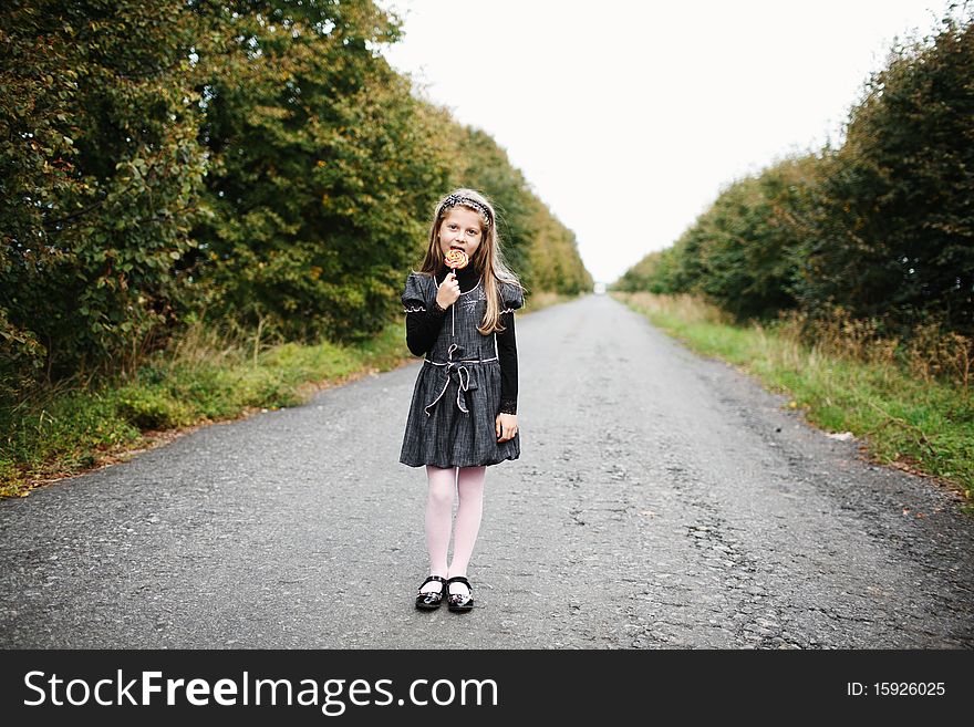 An image of little girl wit candy in his hand. An image of little girl wit candy in his hand