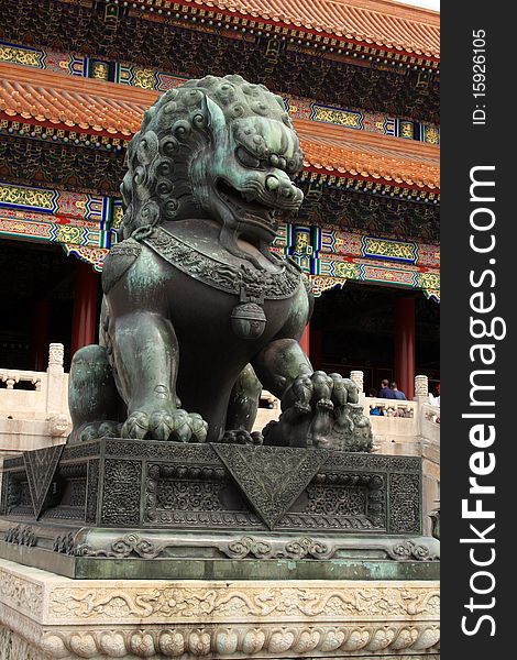 Forbidden City in Beijing Bronze lion at entrance of The Forbidden City in Beijing, China.