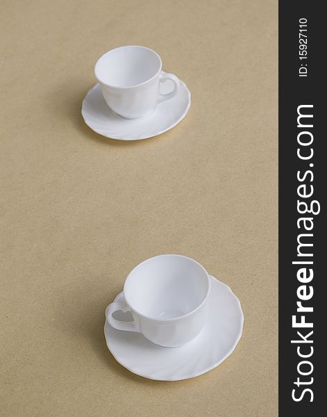 Two white empty coffee cups on table. Two white empty coffee cups on table.