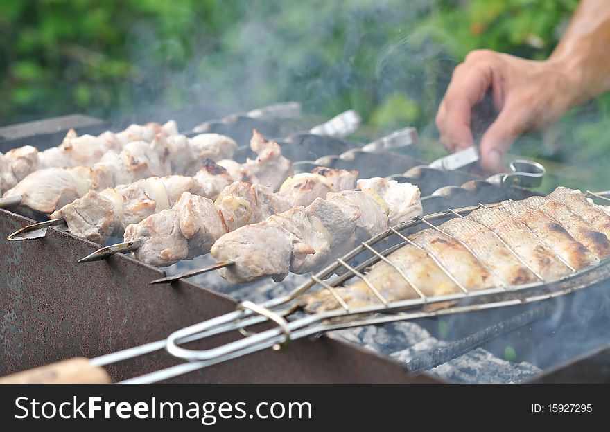 Preparation of kebab and trout on the brazier