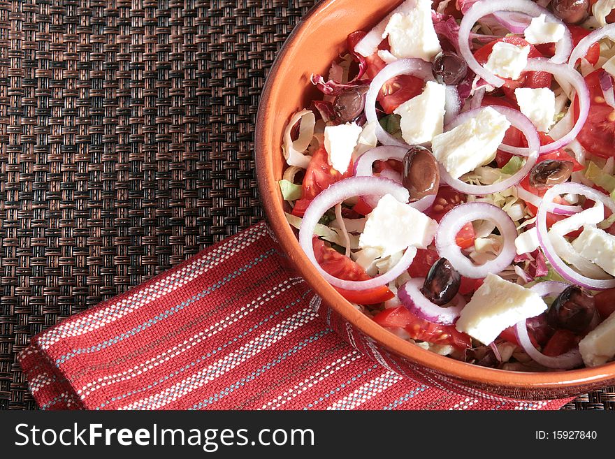 Greek salad in an earthenware bowl