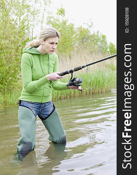 Young woman fishing in pond. Young woman fishing in pond