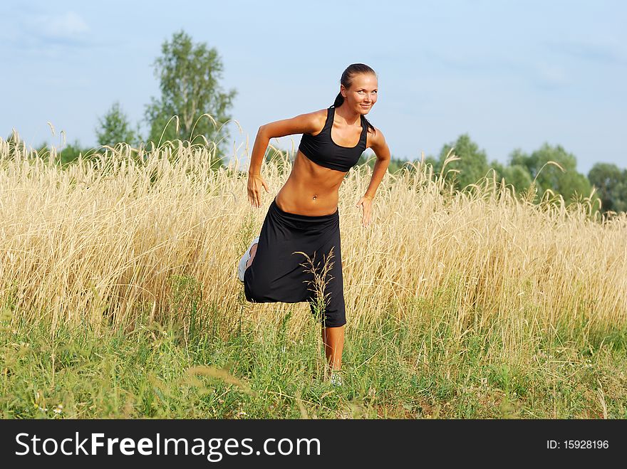 Young attractive woman doing morning sports exercises. Young attractive woman doing morning sports exercises