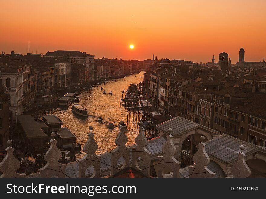 An aerial shot of Grand Canal and high buildings, in Venice during golden hour