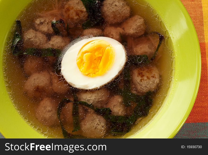 Soup with meatballs and an egg