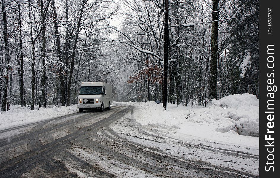 Truck on a road in a snowy forest