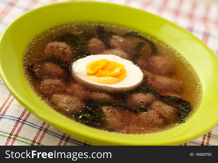 Soup with meatballs and an egg