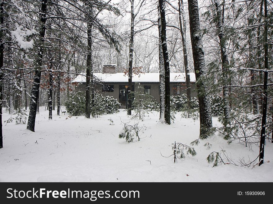 House in winter snow surrownded by forest trees. House in winter snow surrownded by forest trees