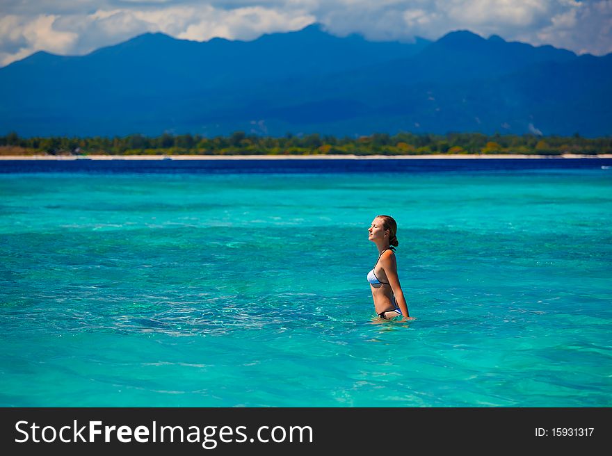 Woman Wearing  White Bikini Facing The Sea