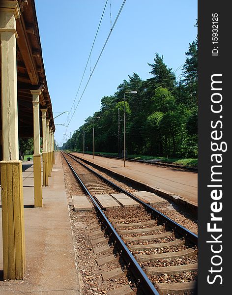 A view of a railway track with railroad station platform. A view of a railway track with railroad station platform