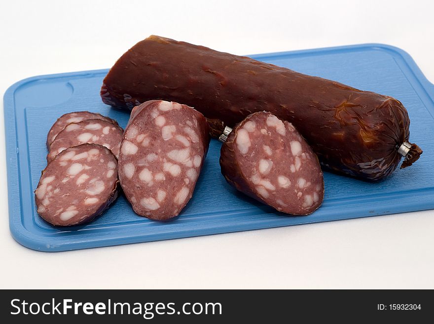 Sausage on a chopping board on a white background