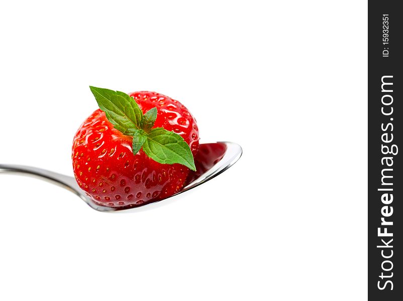 Strawberry on spoon isolated on white