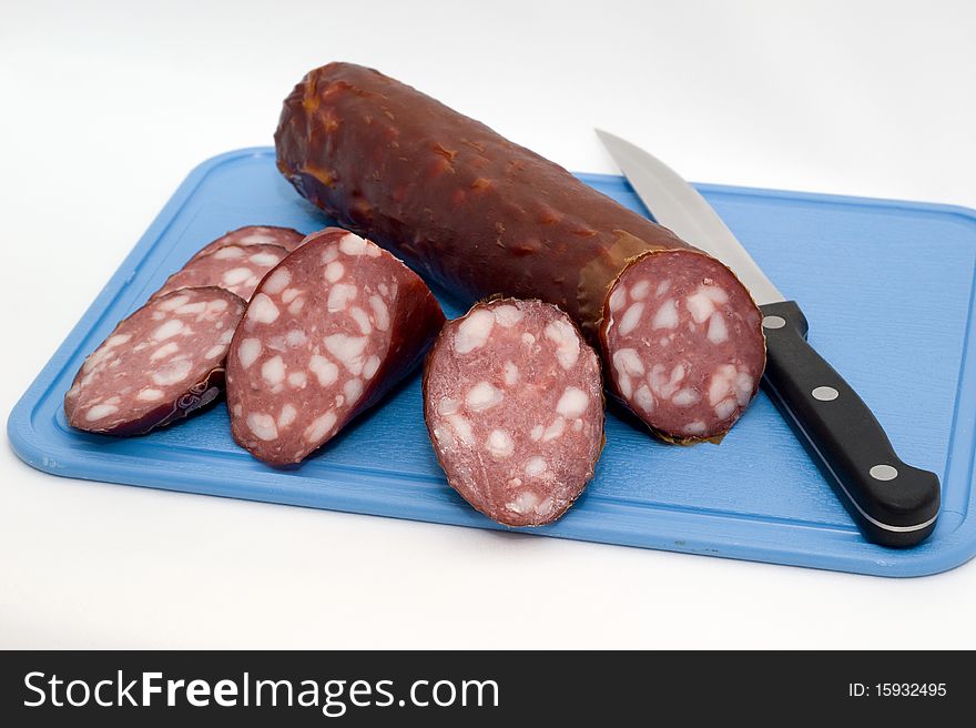 Sausage on a chopping board on a white background