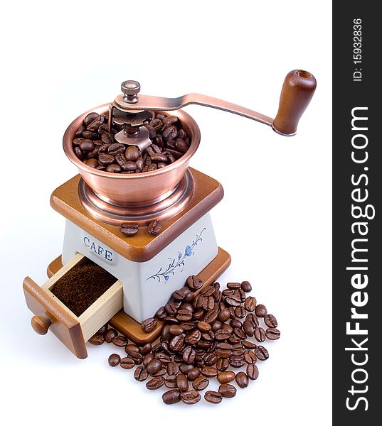Old coffee grinder with coffee grains