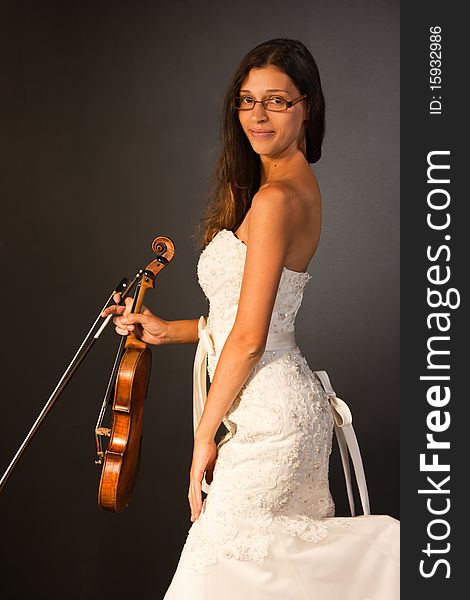 Young violinist holding a violin and bow. Young violinist holding a violin and bow